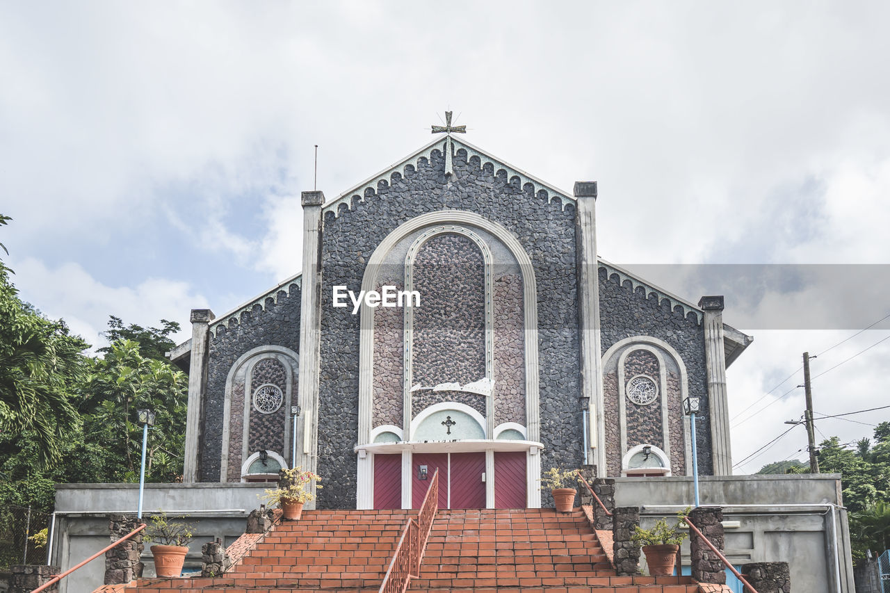 Steps and facade of christian church with stone walls. entrance to a chapel in roseau, dominica