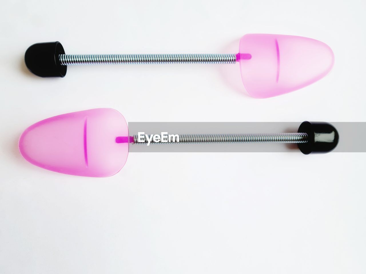 CLOSE-UP OF EYEGLASSES ON PINK BACKGROUND