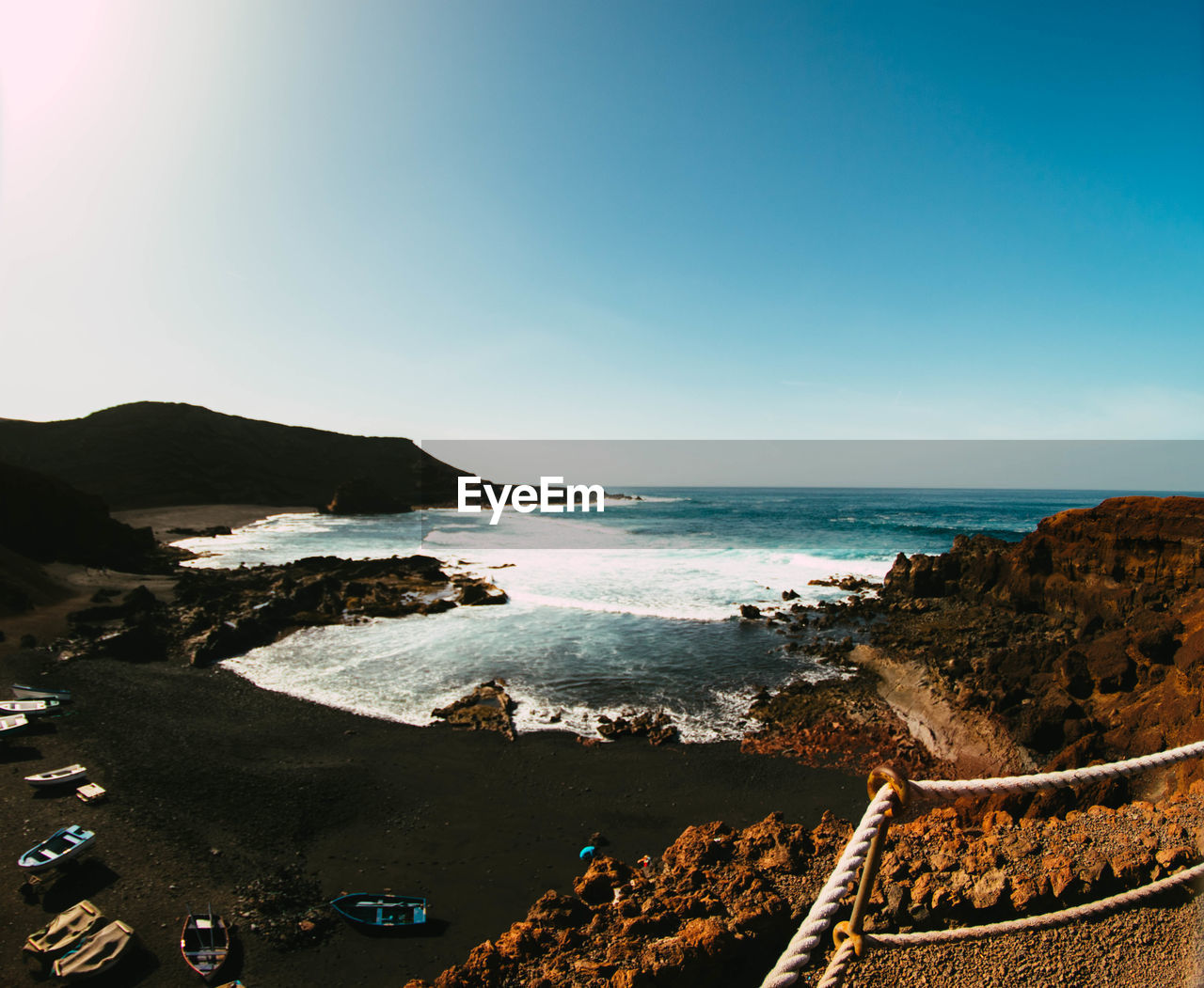 Scenic view of sea against clear blue sky