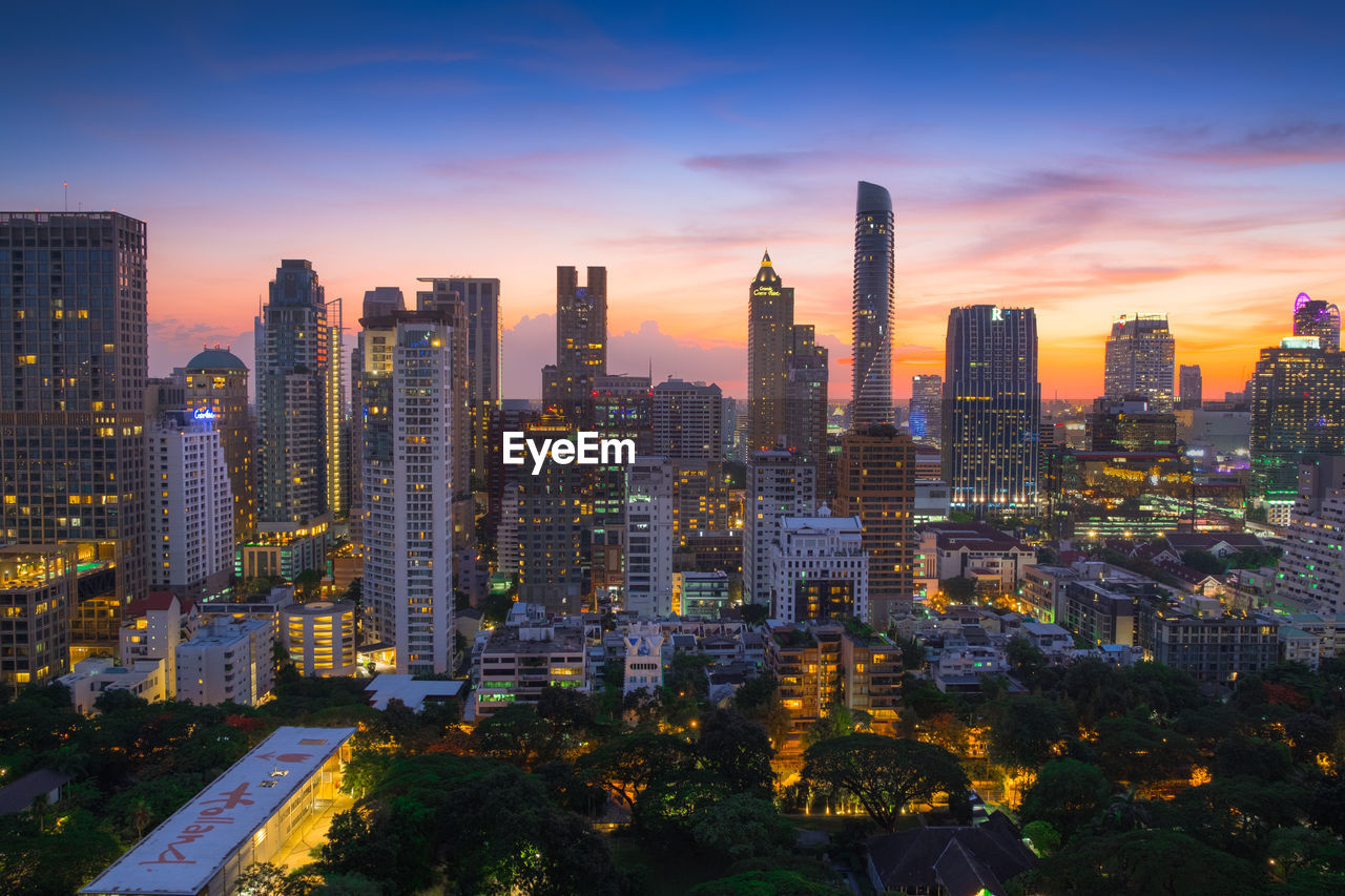 Aerial view of buildings against sky during sunset