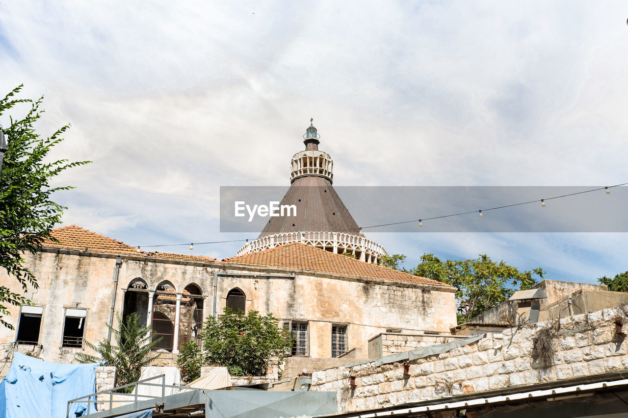 architecture, built structure, building exterior, sky, travel destinations, town, history, building, the past, nature, cloud, landmark, religion, travel, place of worship, tourism, tower, city, belief, no people, tree, day, spirituality, vacation, outdoors, plant, old, water, transportation, blue