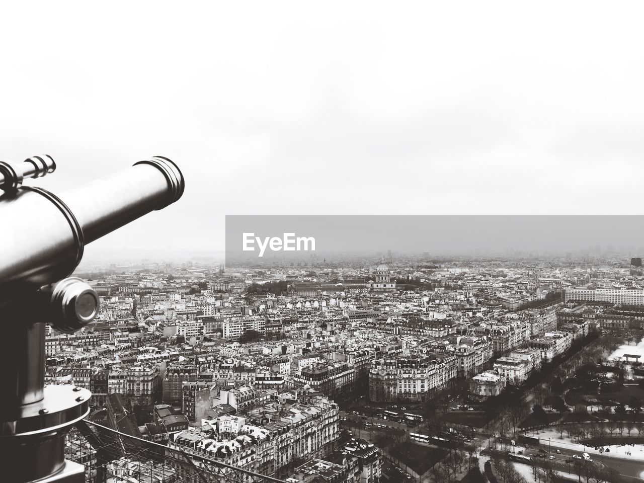 Cannon against cityscape