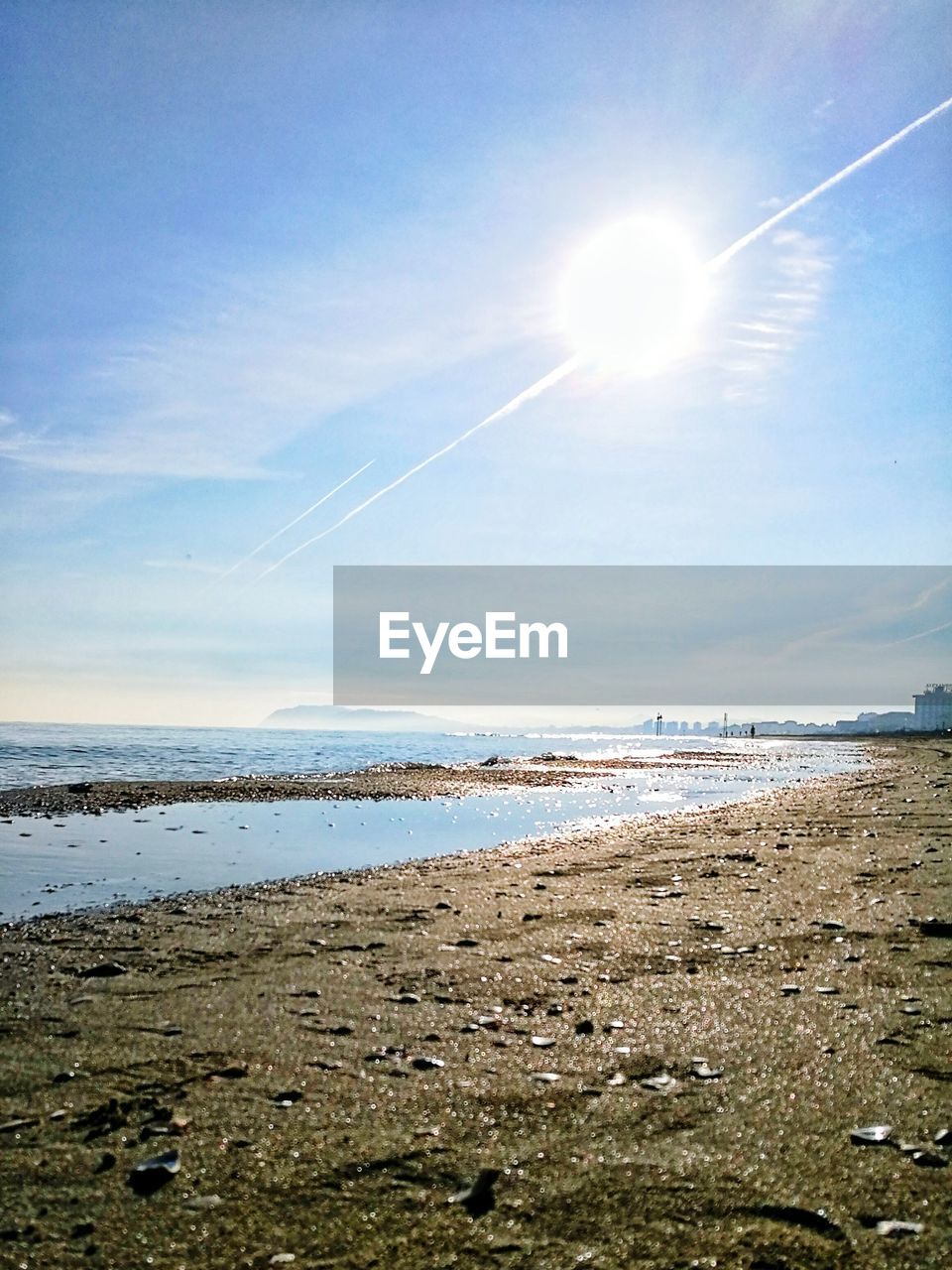 SCENIC VIEW OF BEACH AGAINST BLUE SKY