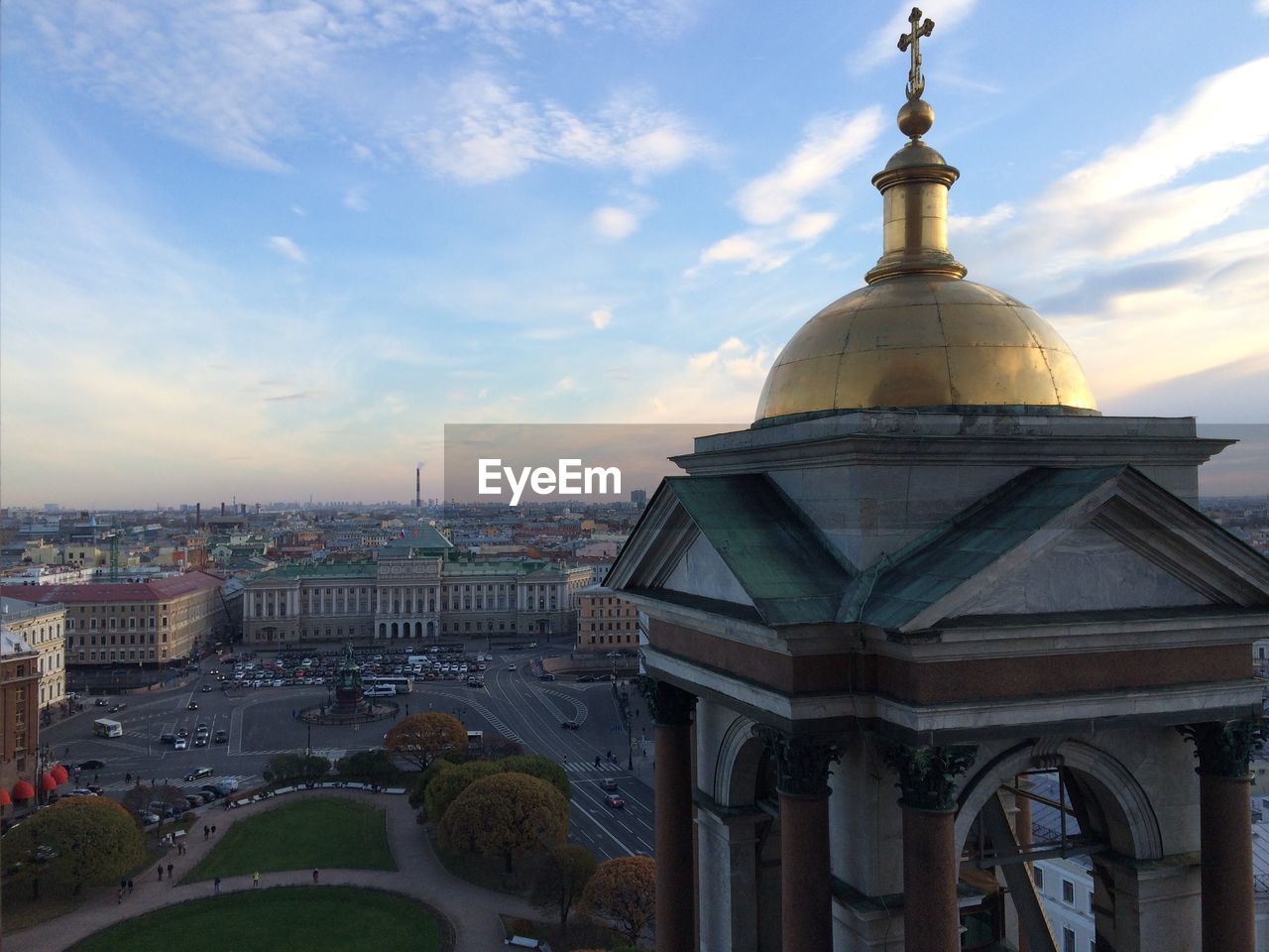 View of cityscape against cloudy sky