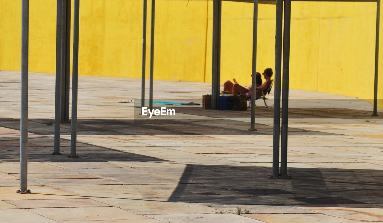 Man and woman sitting on deck chairs