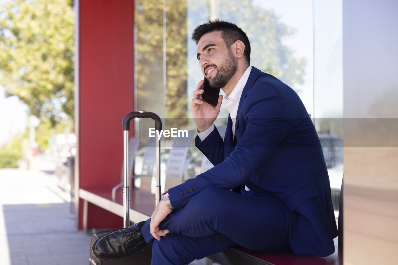 Young man waiting for the arrival of public transport