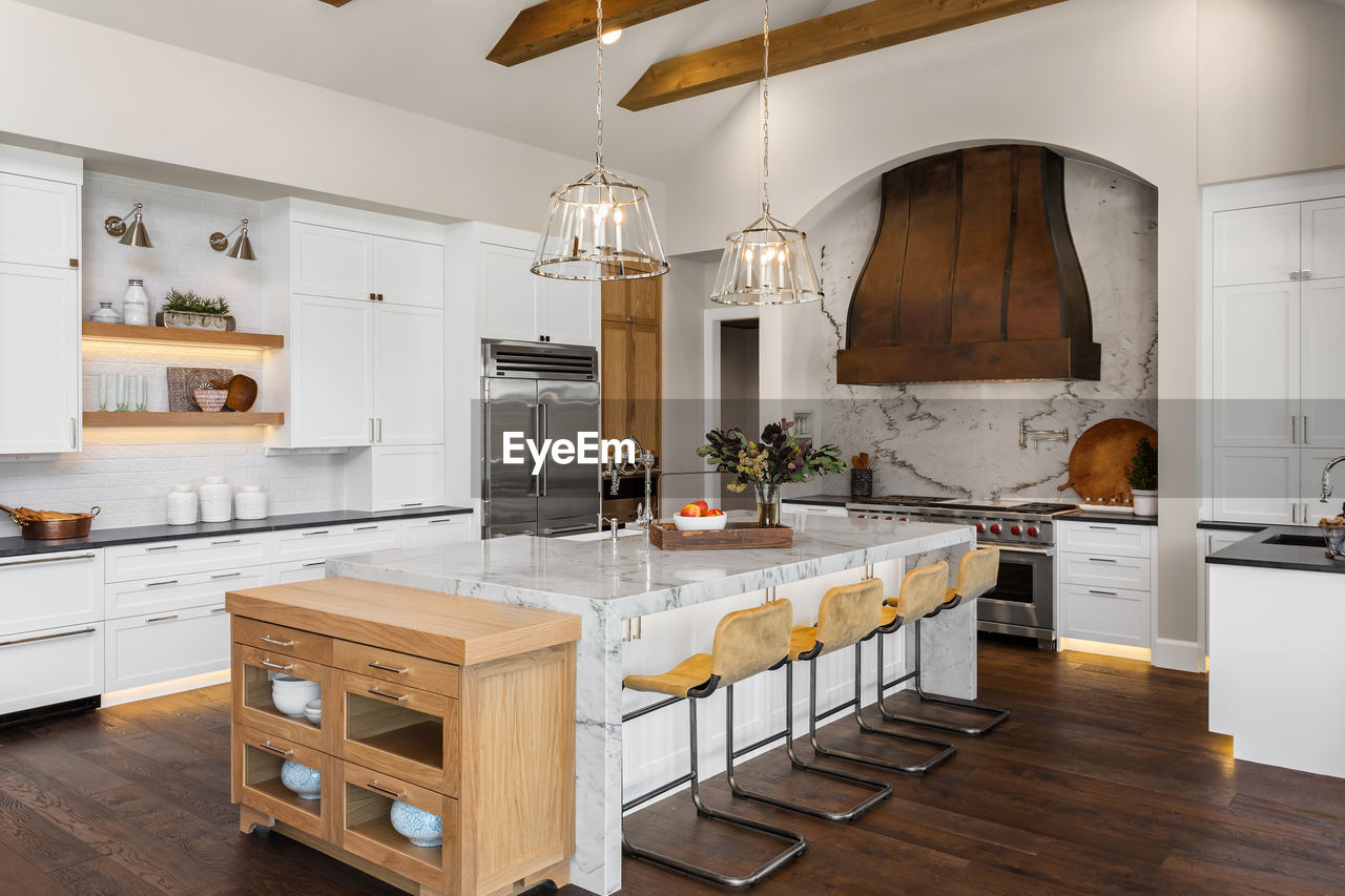 Kitchen in luxury home with large island and hardwood floors