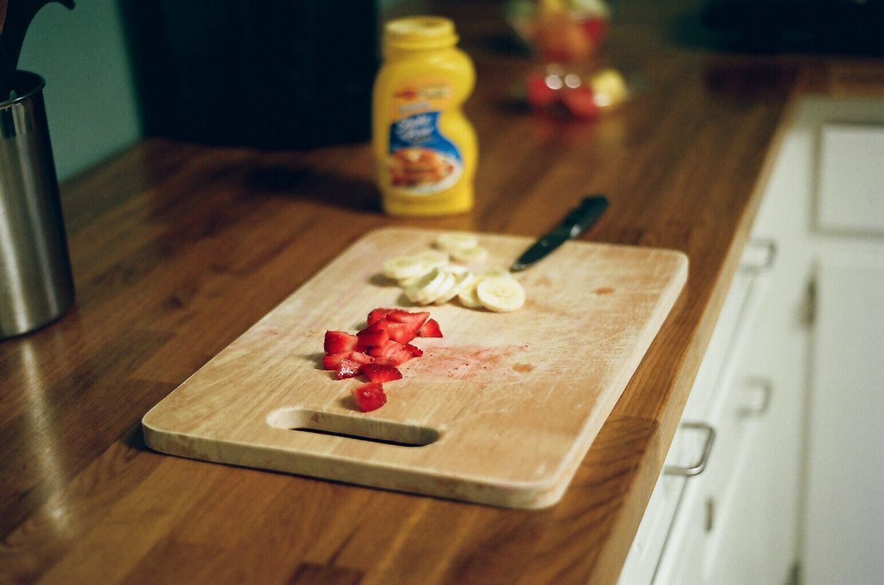 cutting board, food and drink, indoors, food, domestic room, wood, table, no people, bottle, kitchen, domestic kitchen, red, domestic life, home, home interior, still life, container