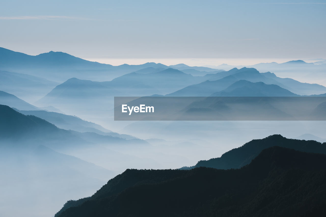 Silhouette of mountains looking like sheets of papers during sunrise at uttarakhand, india