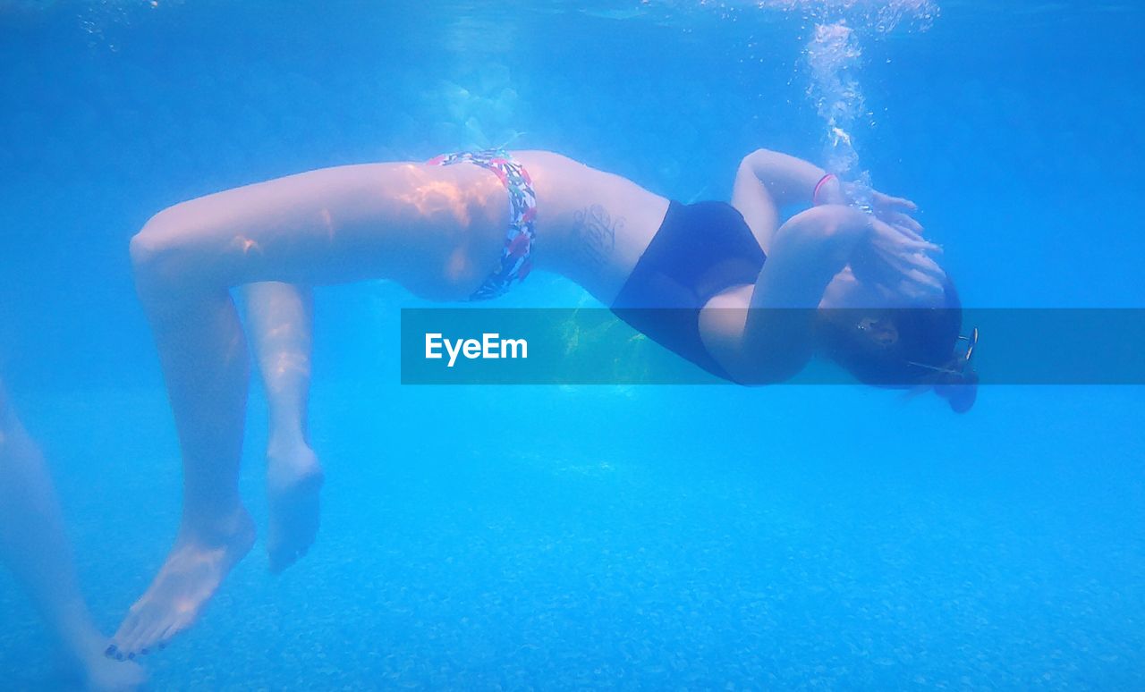 Full length of woman swimming in pool