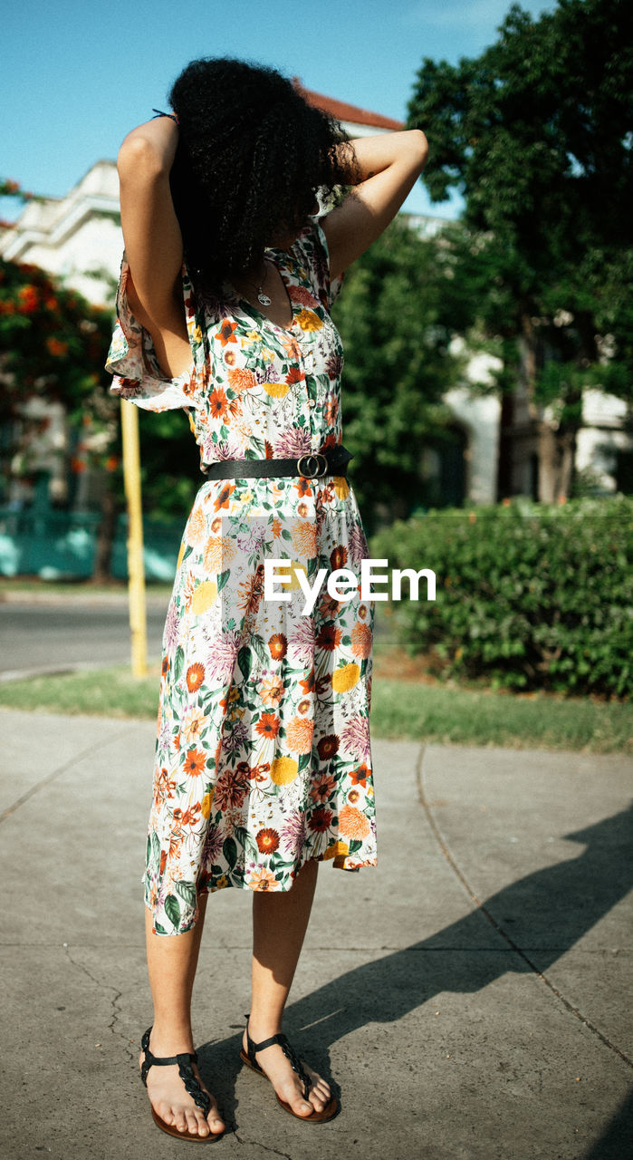 Rear view of woman standing on the street 