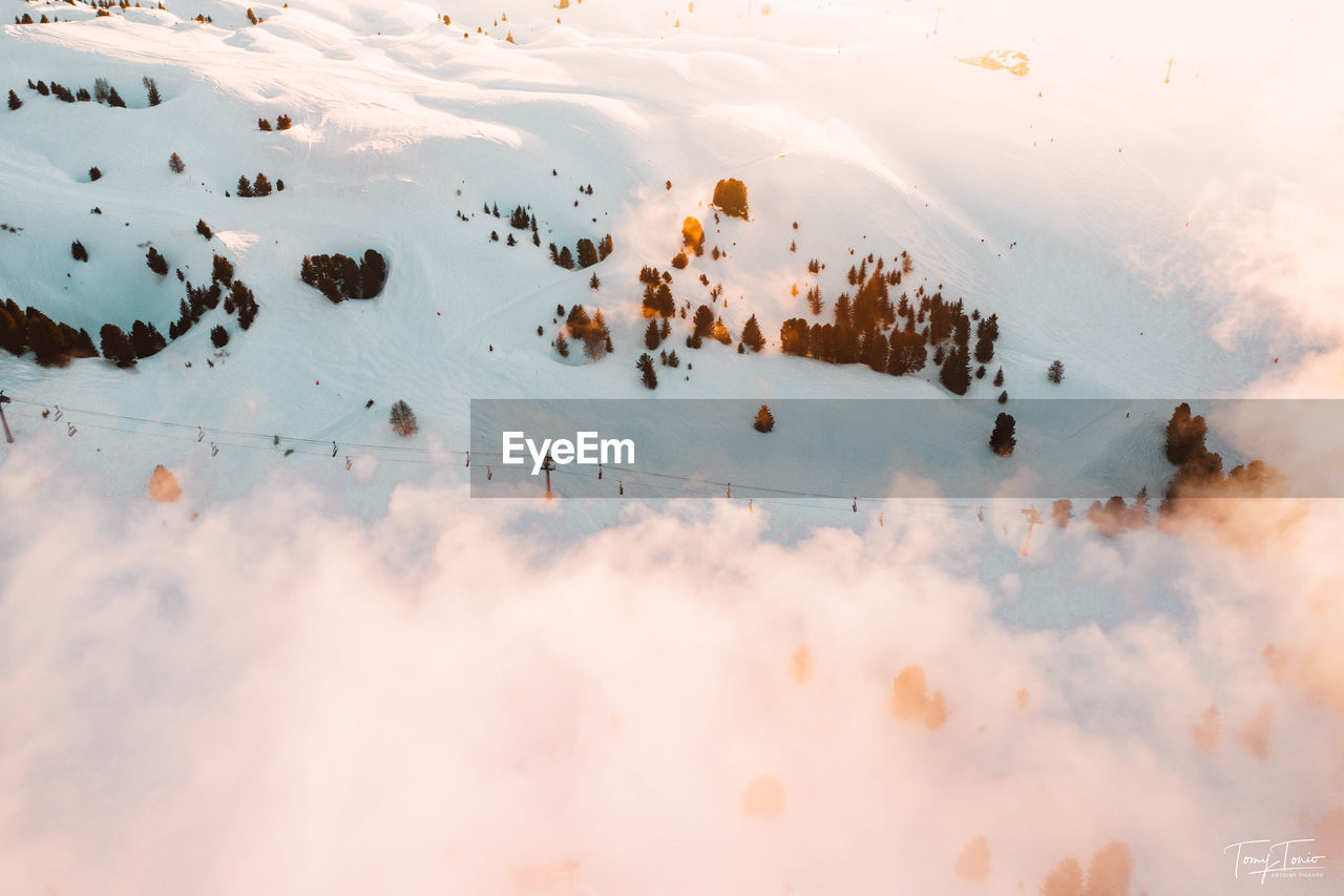 HIGH ANGLE VIEW OF LAND AGAINST SKY DURING SUNSET