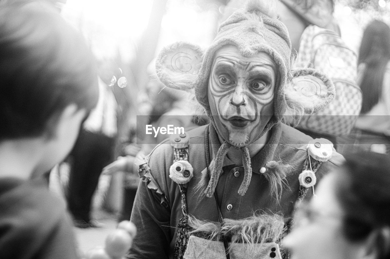 crowd, black and white, adult, monochrome, men, monochrome photography, arts culture and entertainment, celebration, human face, group of people, person, fun, clothing, event, women, portrait, selective focus, lifestyles, mask, disguise, outdoors