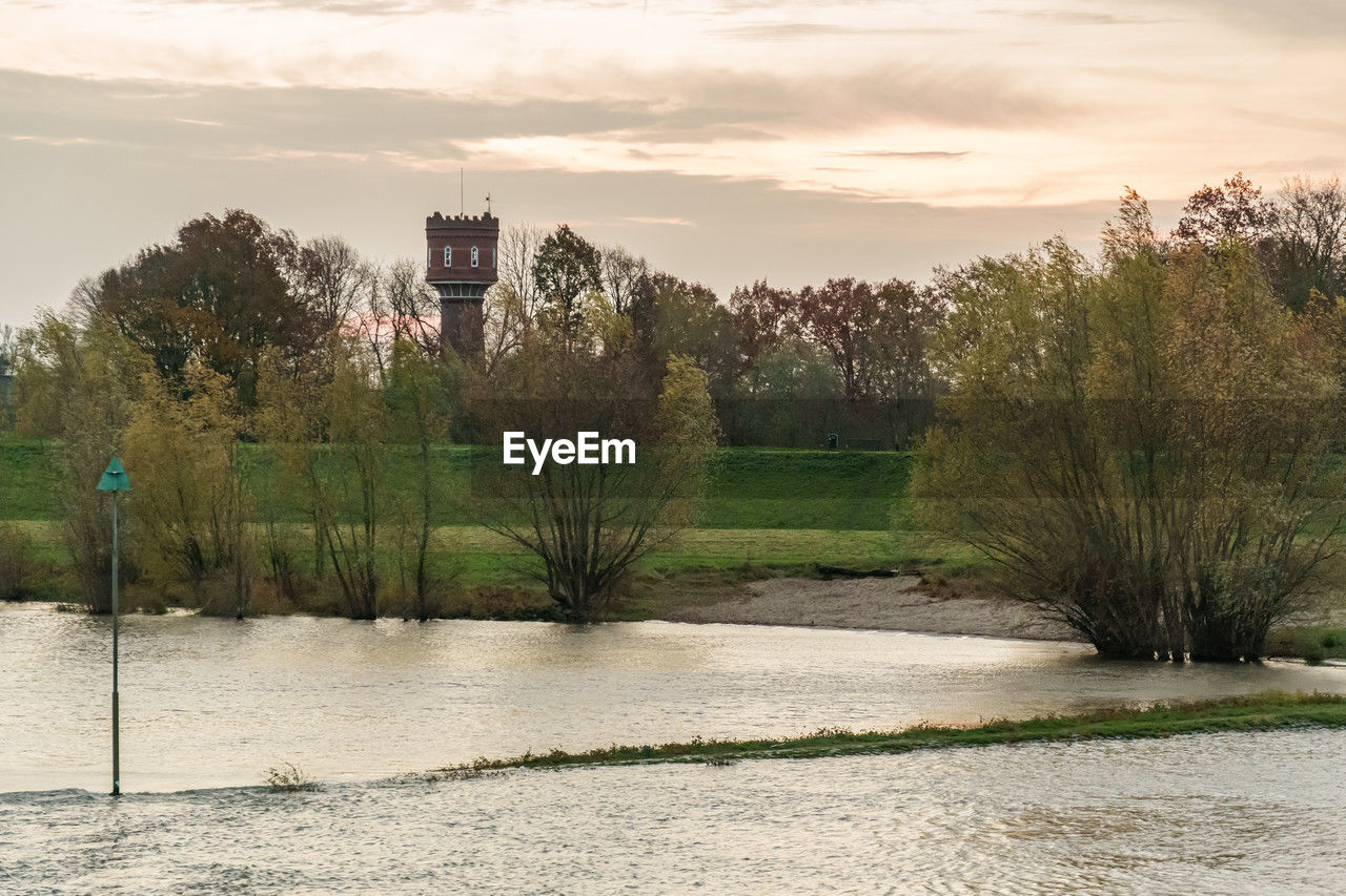 tree, plant, sky, river, nature, water, morning, architecture, reflection, environment, cloud, rural area, landscape, no people, built structure, travel destinations, travel, outdoors, city, land, scenics - nature, building, beauty in nature, tourism, building exterior