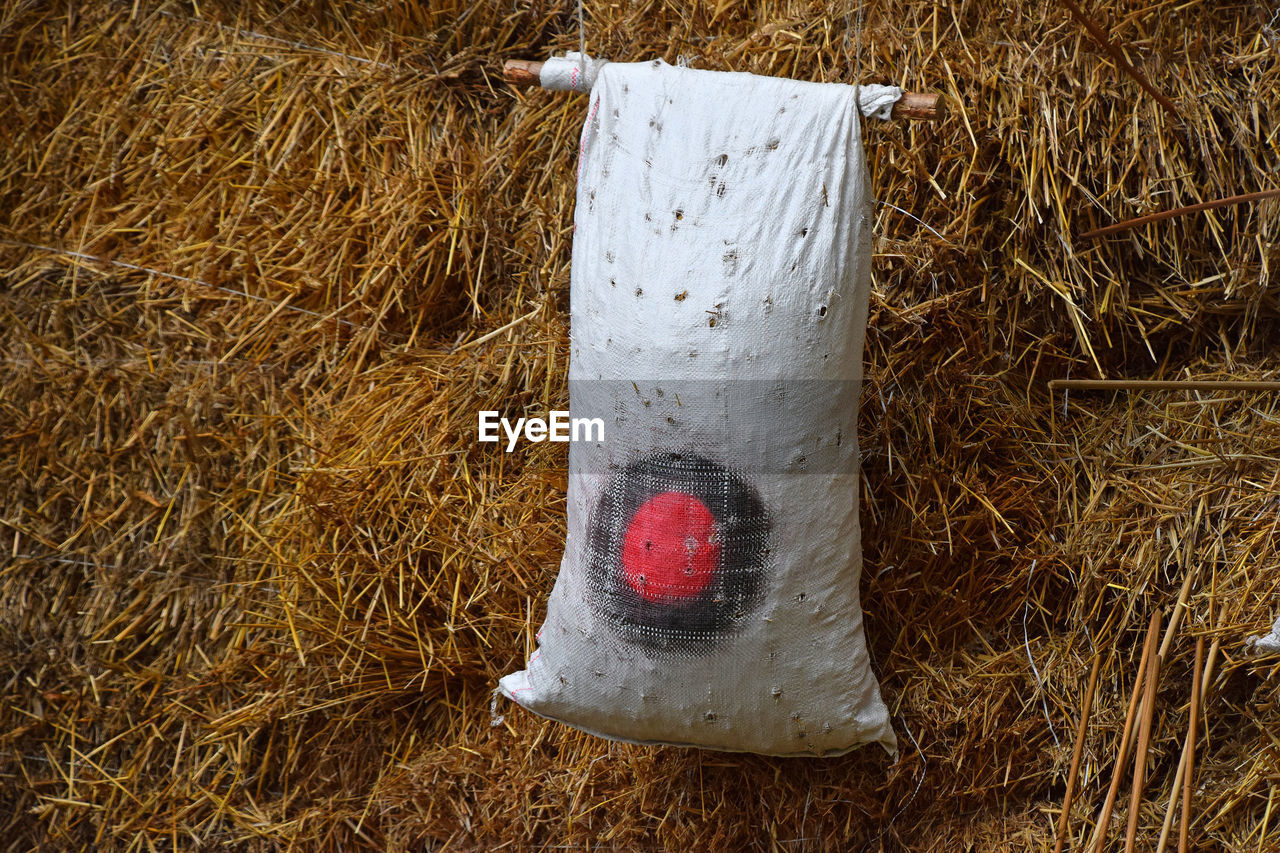 White sack over hay on field