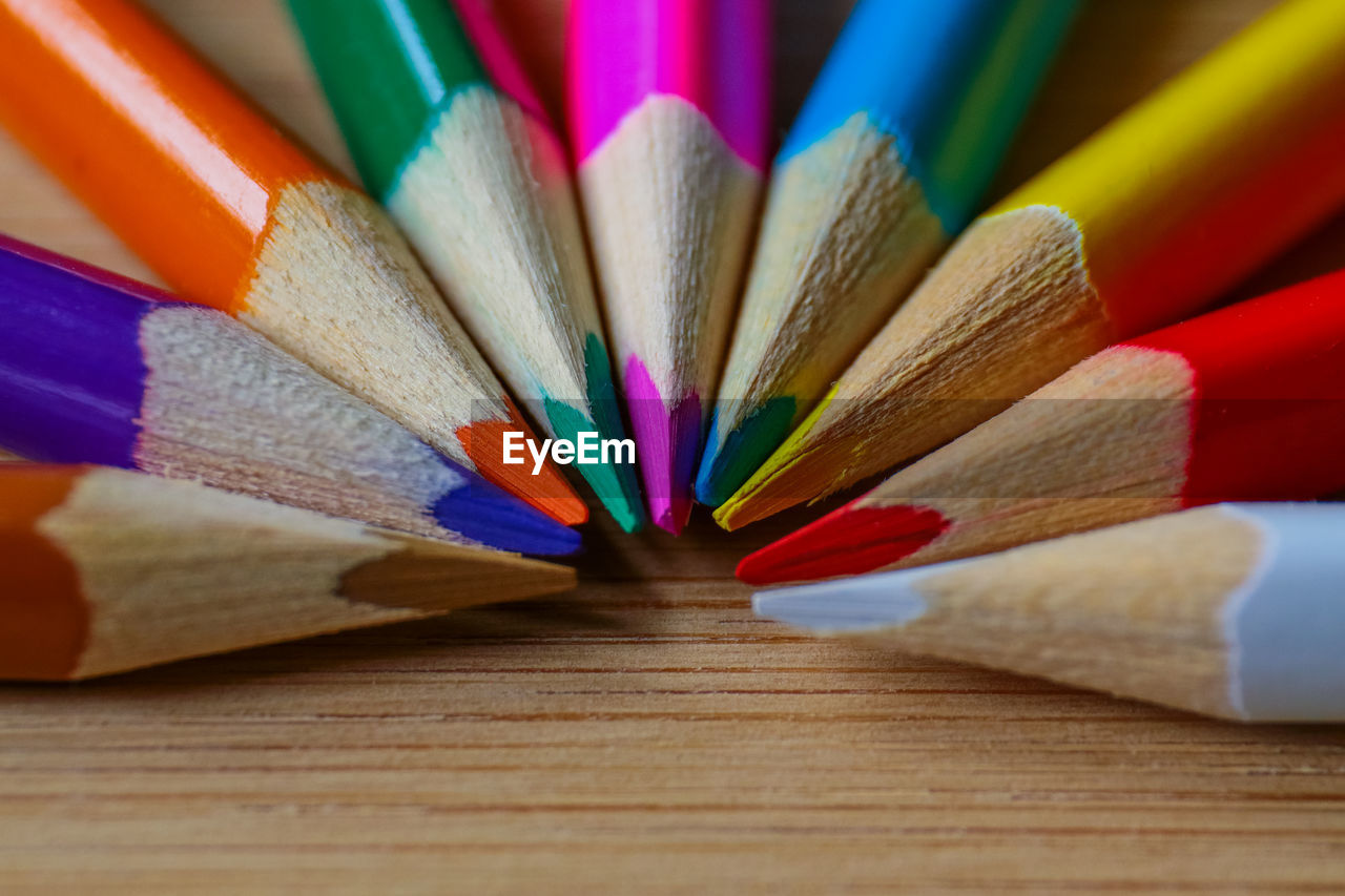 Close-up of multi colored pencils on table