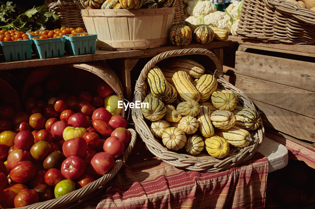 Heirloom tomatoes and winter squash at a farmers market in copley square, boston, massachusetts. 