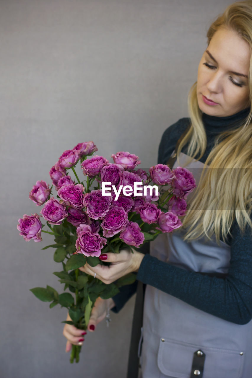 Woman holding purple flowers