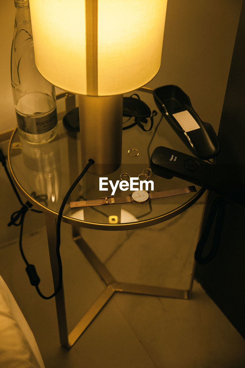 CLOSE-UP OF ILLUMINATED ELECTRIC LAMP ON TABLE