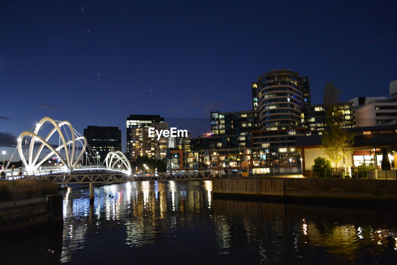 VIEW OF ILLUMINATED CITYSCAPE AT NIGHT