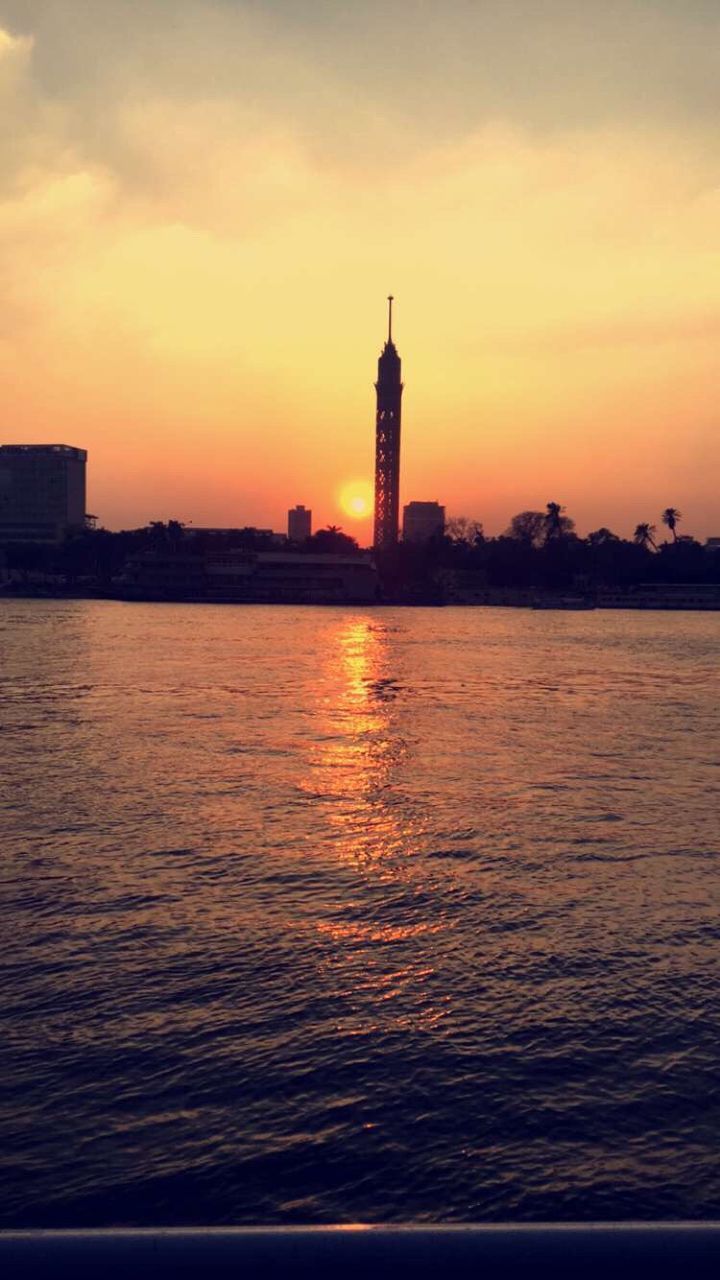 SILHOUETTE OF LIGHTHOUSE IN SEA