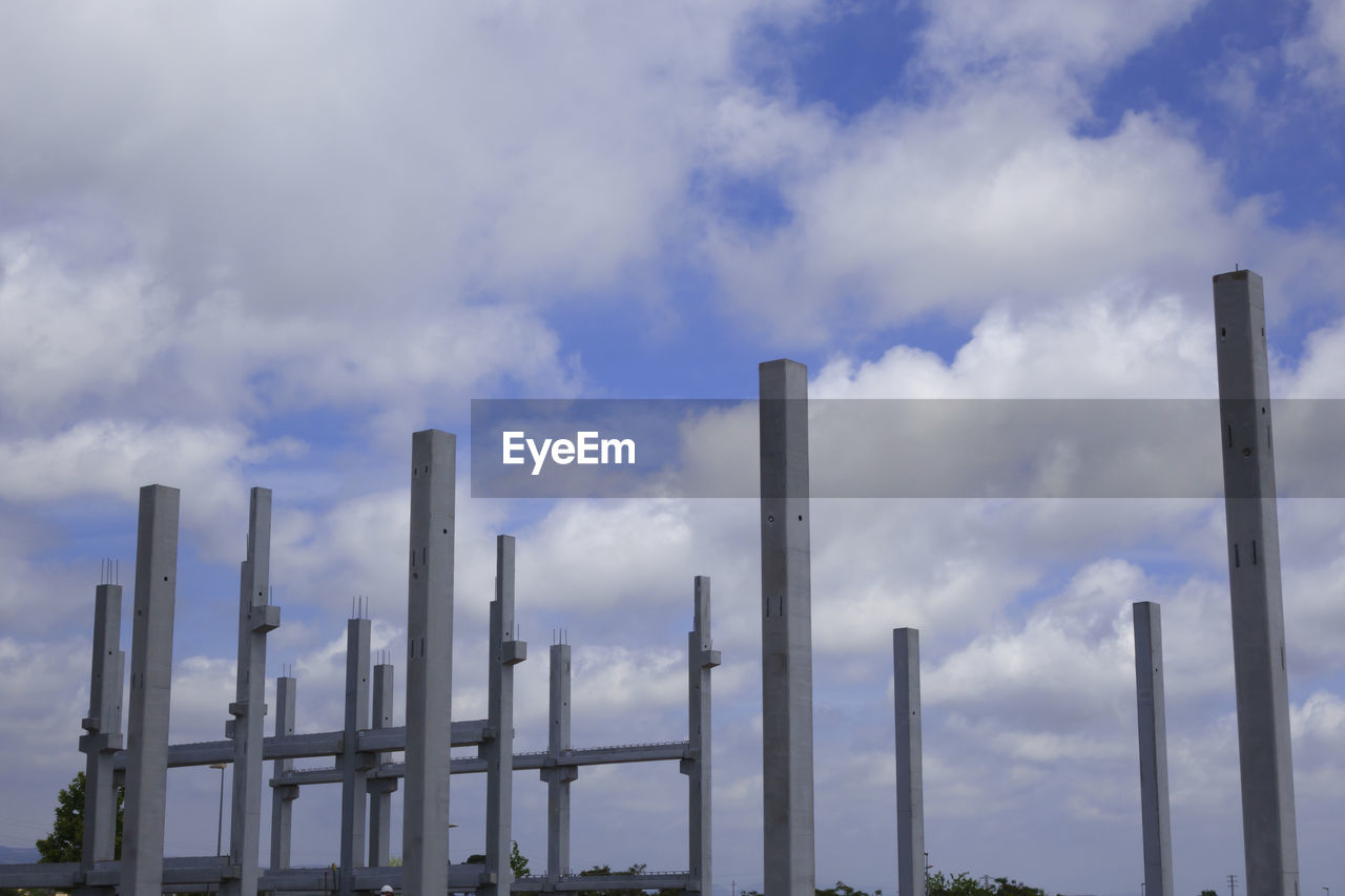 LOW ANGLE VIEW OF SMOKE STACKS AGAINST SKY