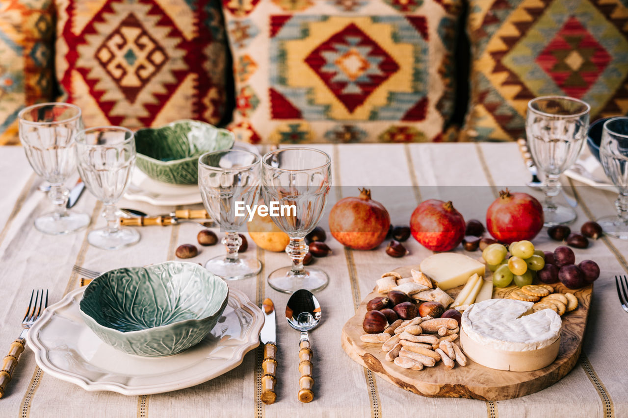 Table served with tableware and assorted ripe fruits and delicious appetizers on terrace