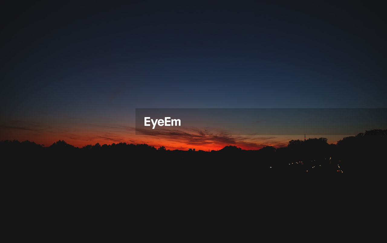 SILHOUETTE LANDSCAPE AGAINST SKY AT SUNSET