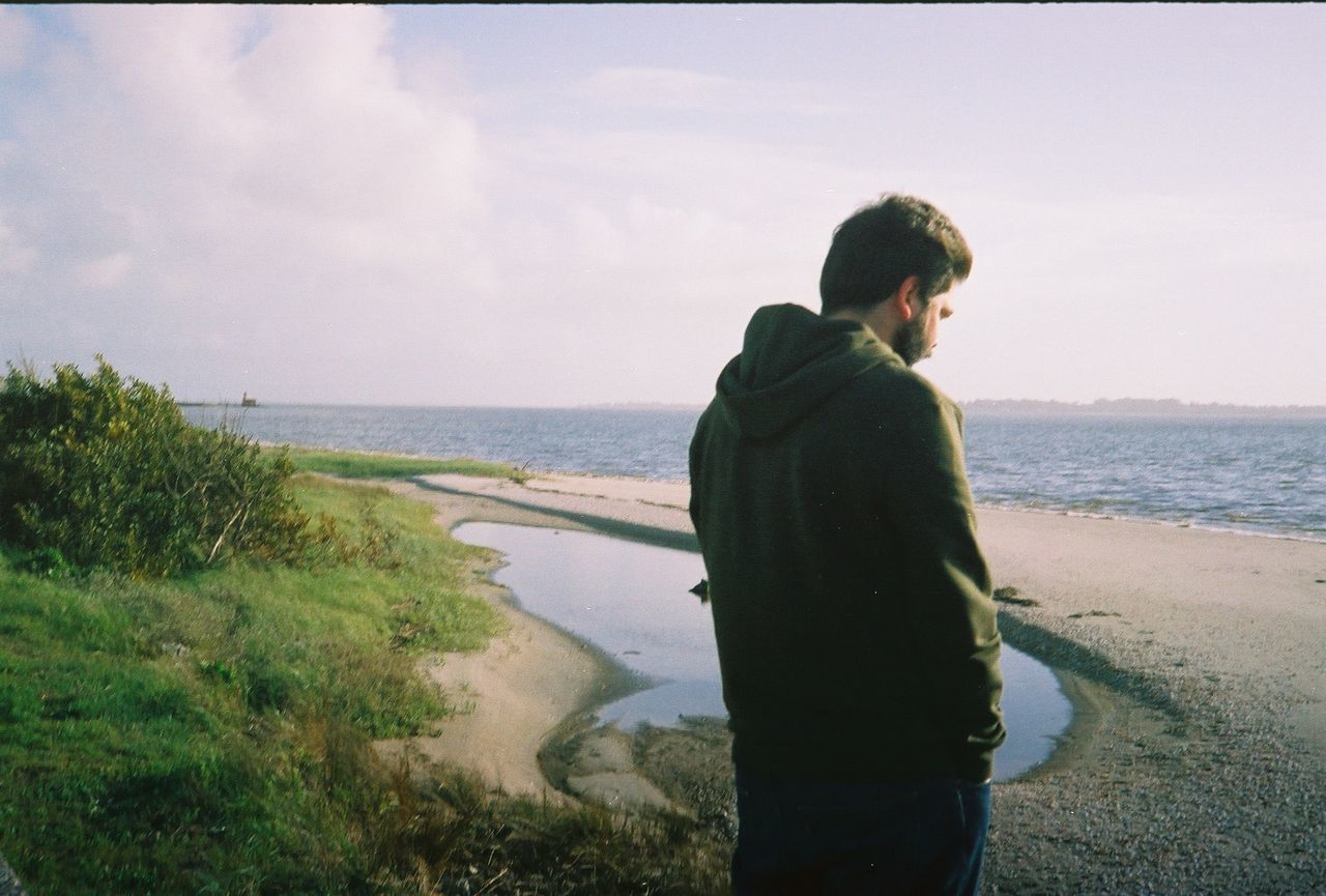 MAN STANDING ON BEACH