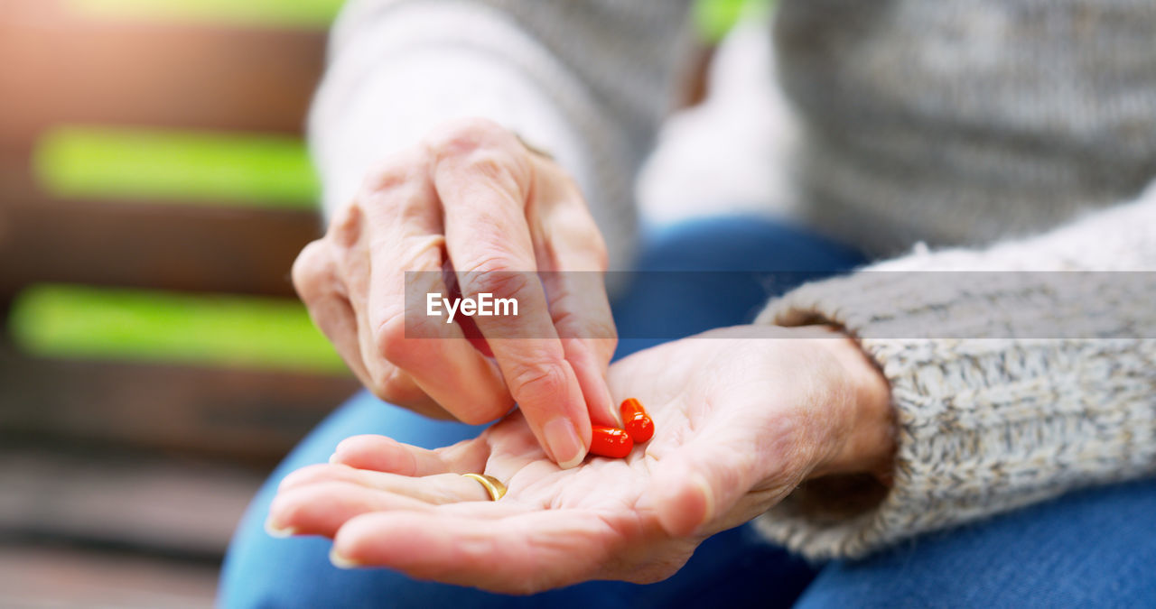 cropped hand of woman playing with toy