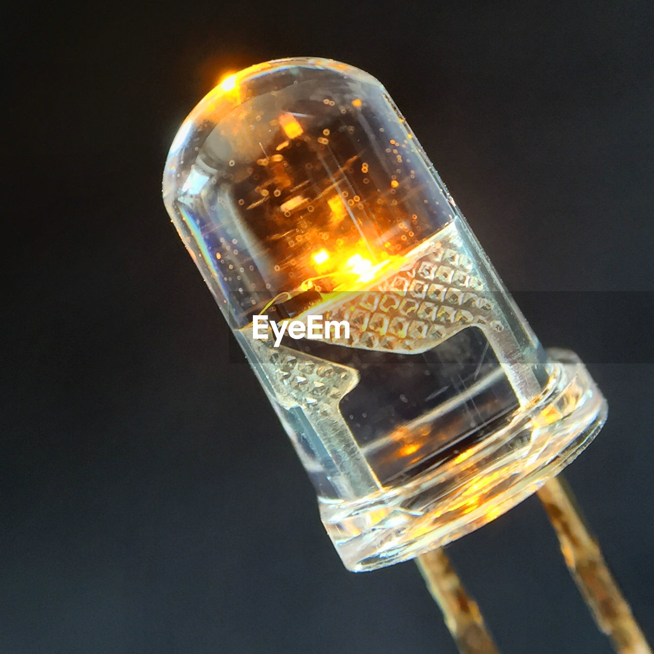 Close-up of lit bulb against blurred background