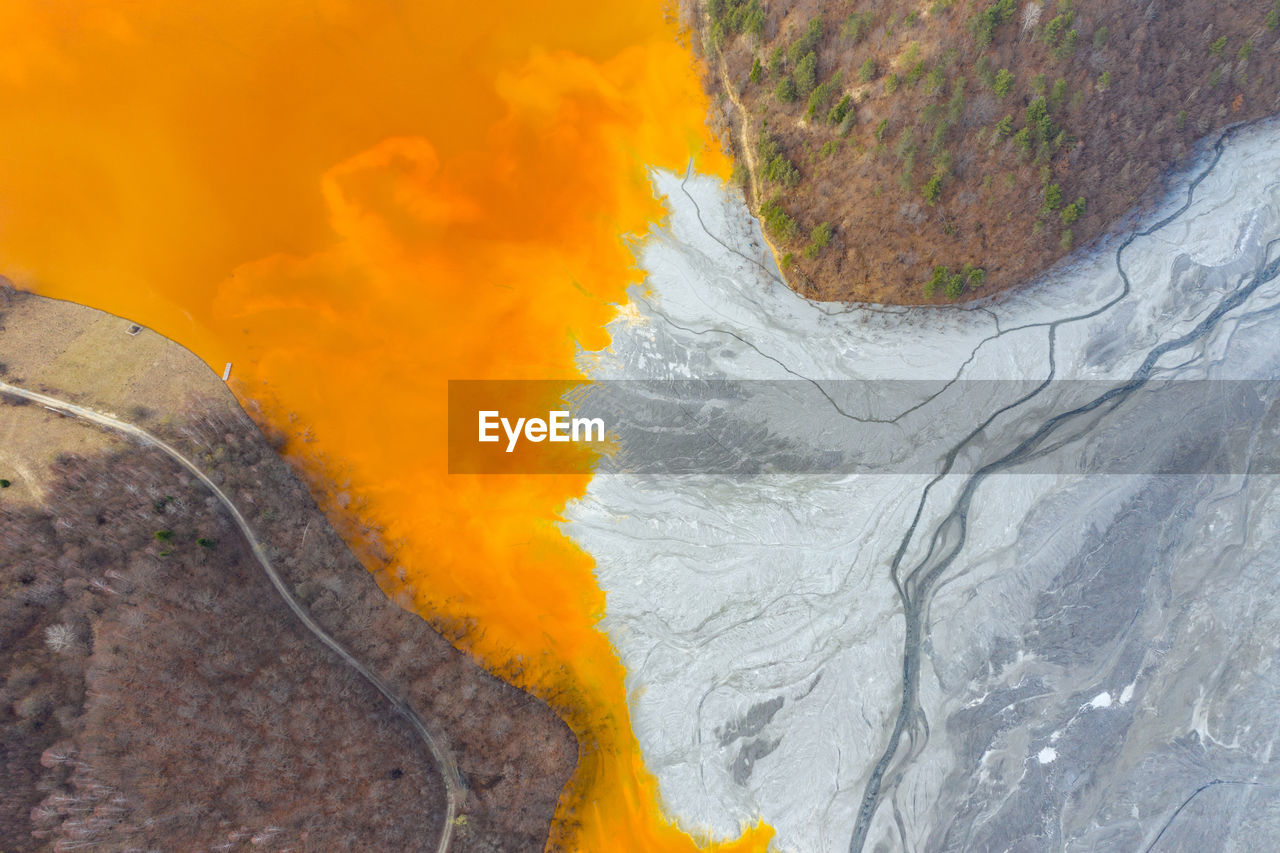 Lake polluted with yellow waste water, aerial view of mining decanting pond  from copper mine