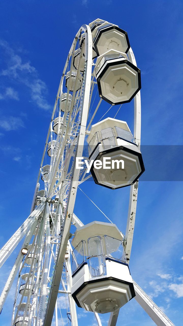 Low angle view of ferris wheel against sky