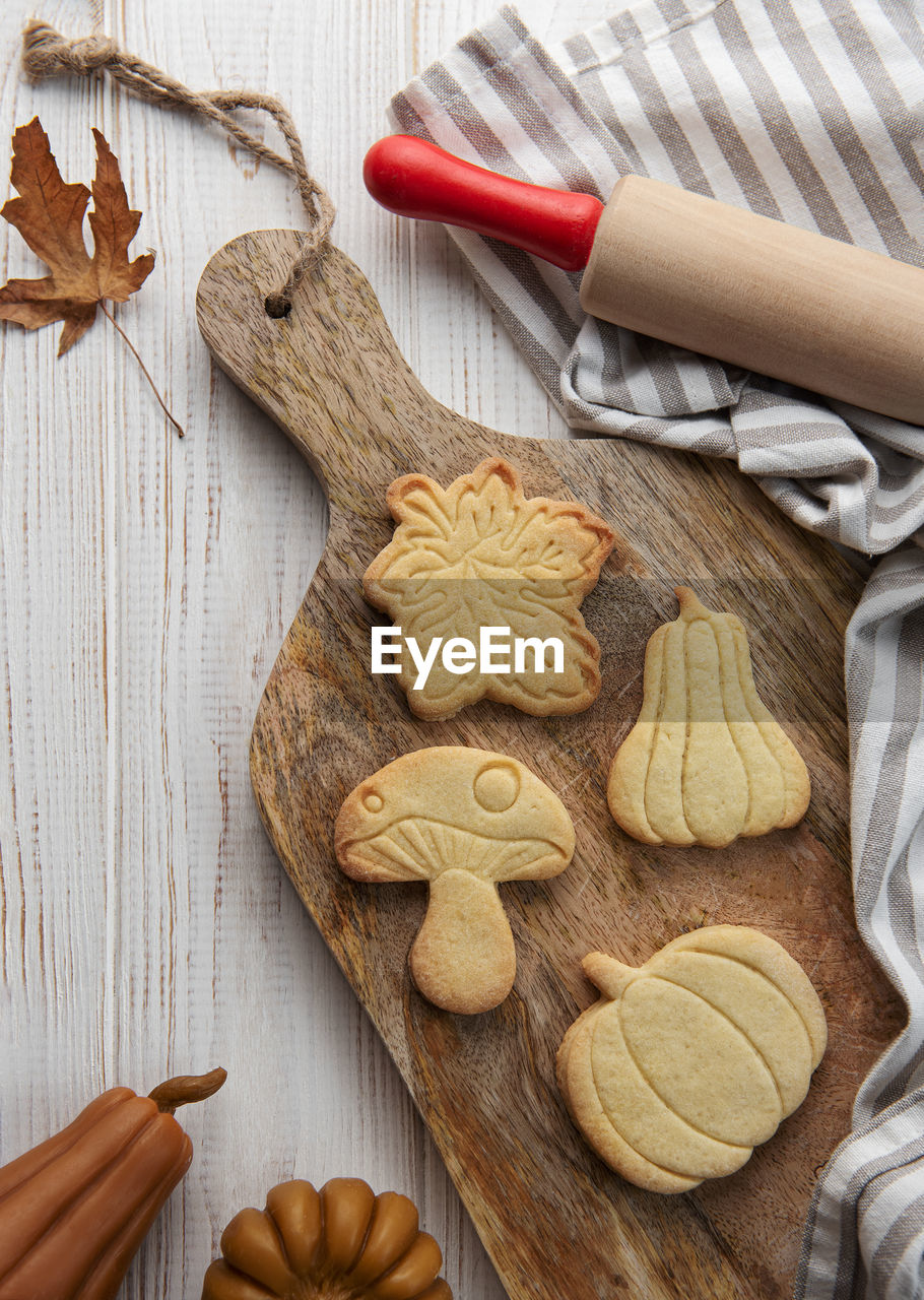 Autumn baking. cookies in the form of pumpkin and leaves on the table. cozy autumn concept.