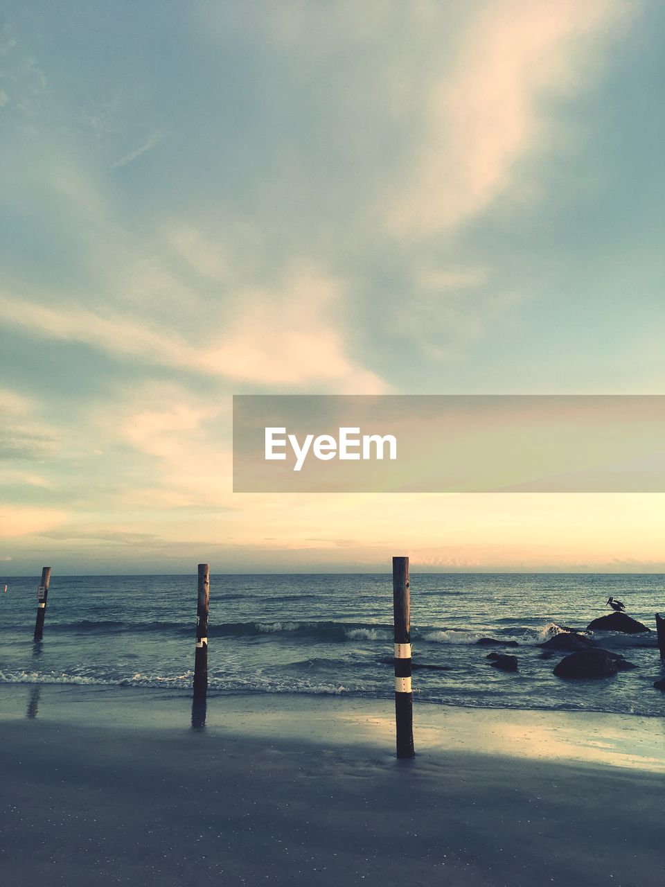 Scenic view of beach against sky during sunset