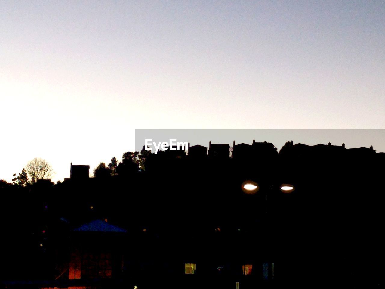 LOW ANGLE VIEW OF SILHOUETTE BUILDINGS AGAINST SKY DURING SUNSET