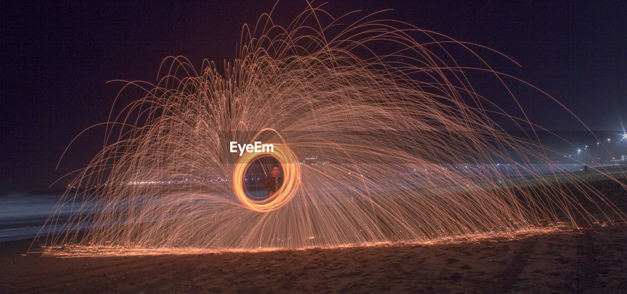 Light painting against sky at night