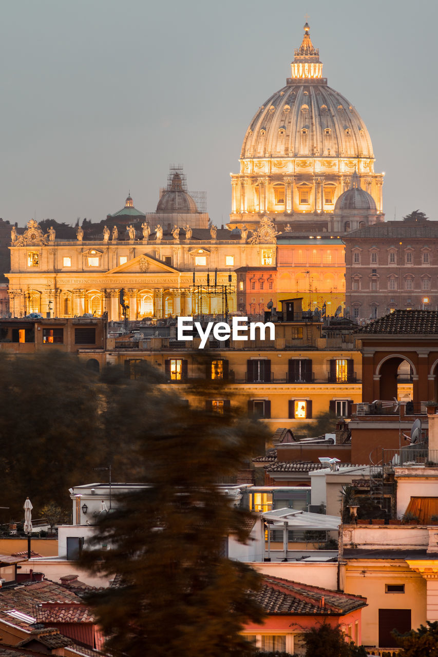 Illuminated buildings in city against sky of rome 