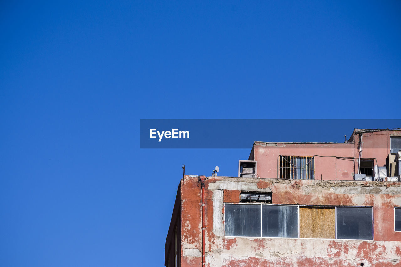 ABANDONED BUILT STRUCTURES AGAINST CLEAR BLUE SKY