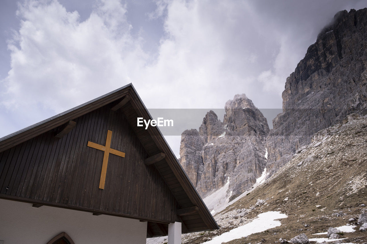 mountain, snow, sky, mountain range, cloud, architecture, winter, cold temperature, nature, scenics - nature, landscape, environment, built structure, building exterior, travel destinations, beauty in nature, building, travel, land, no people, outdoors, religion, snowcapped mountain, house, hut, tourism, rock, holiday, vacation, mountain peak, trip, day