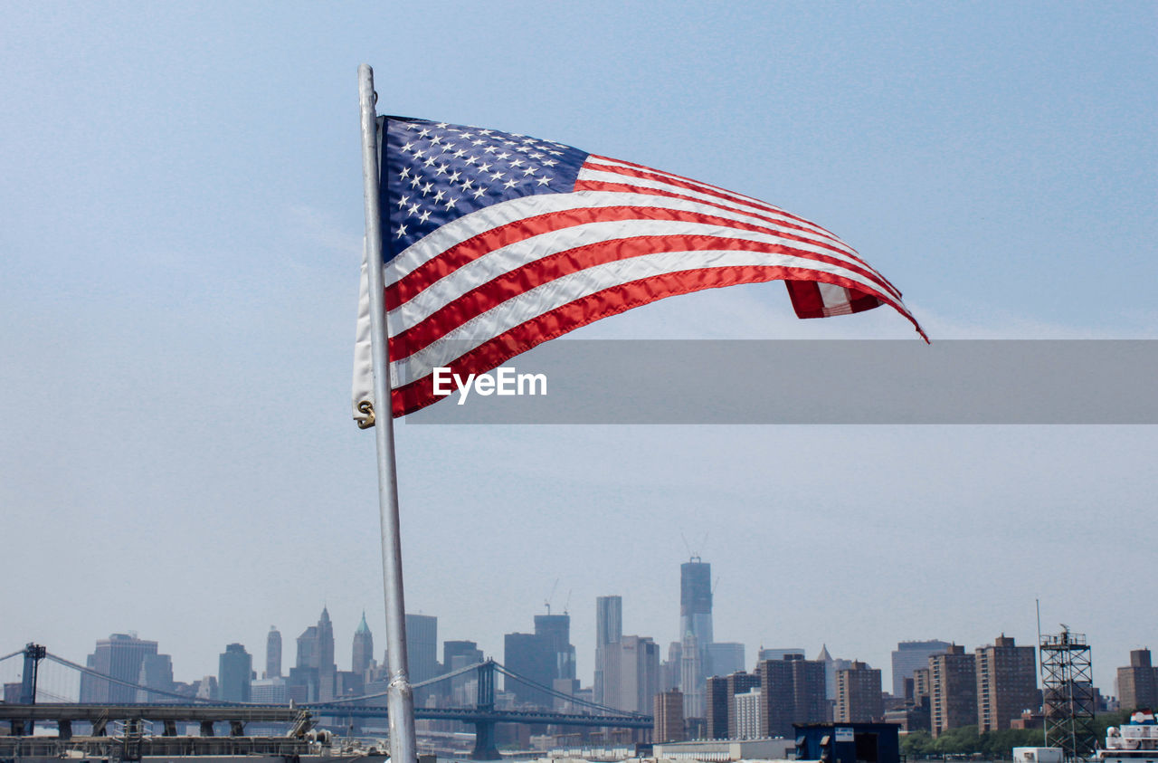American flag against buildings