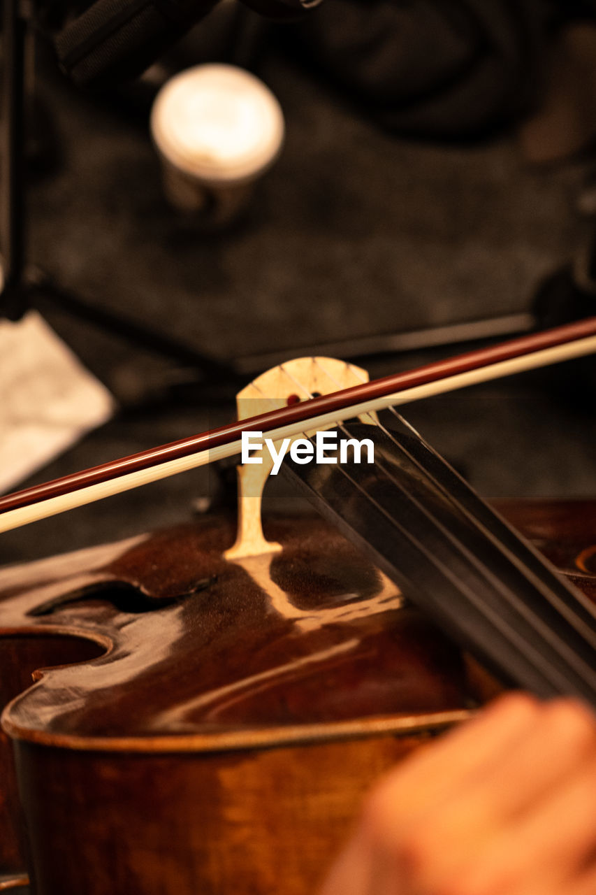 Midsection of person playing violin during orchestra