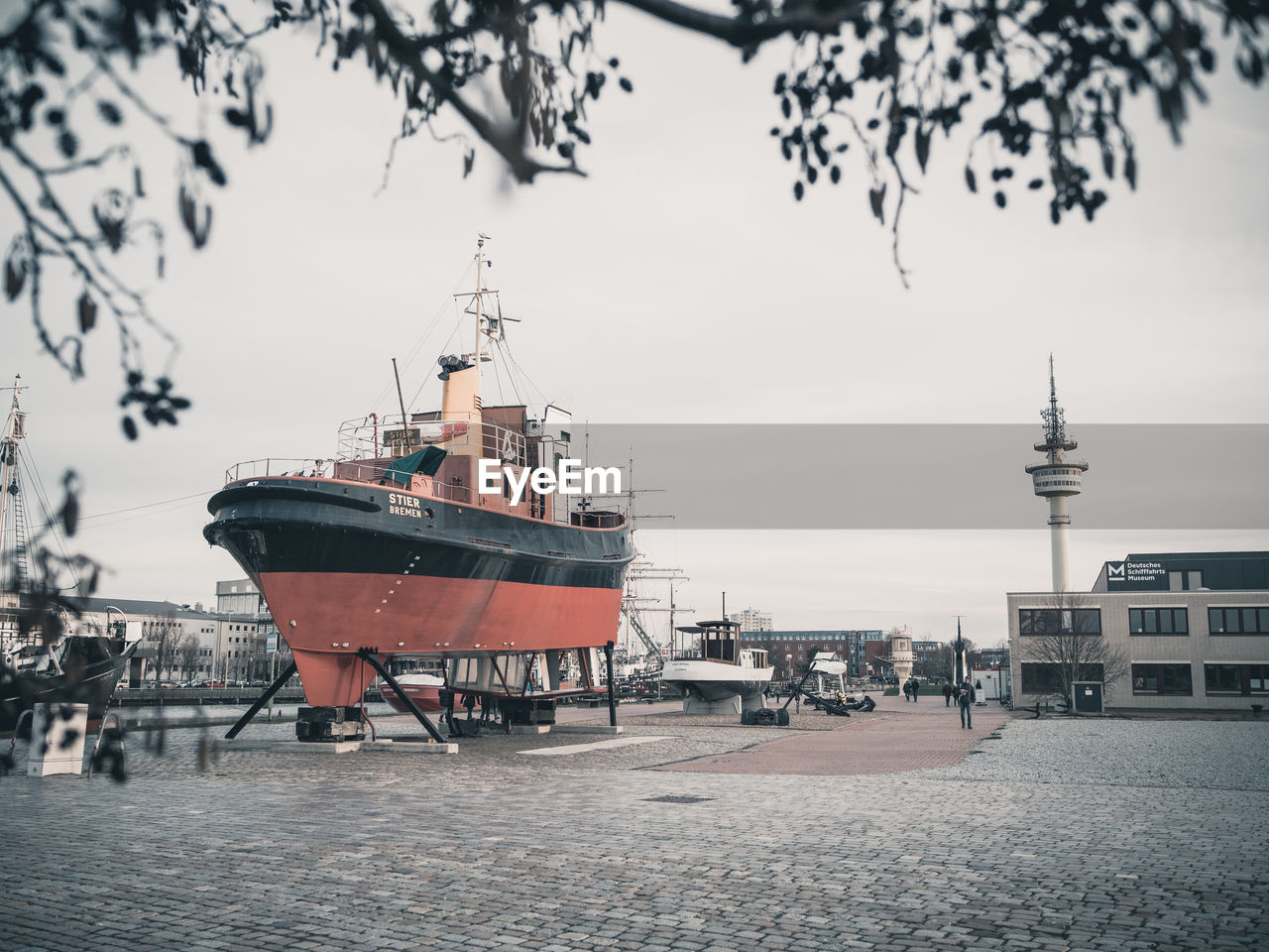 CONTAINER SHIP IN HARBOR AGAINST SKY