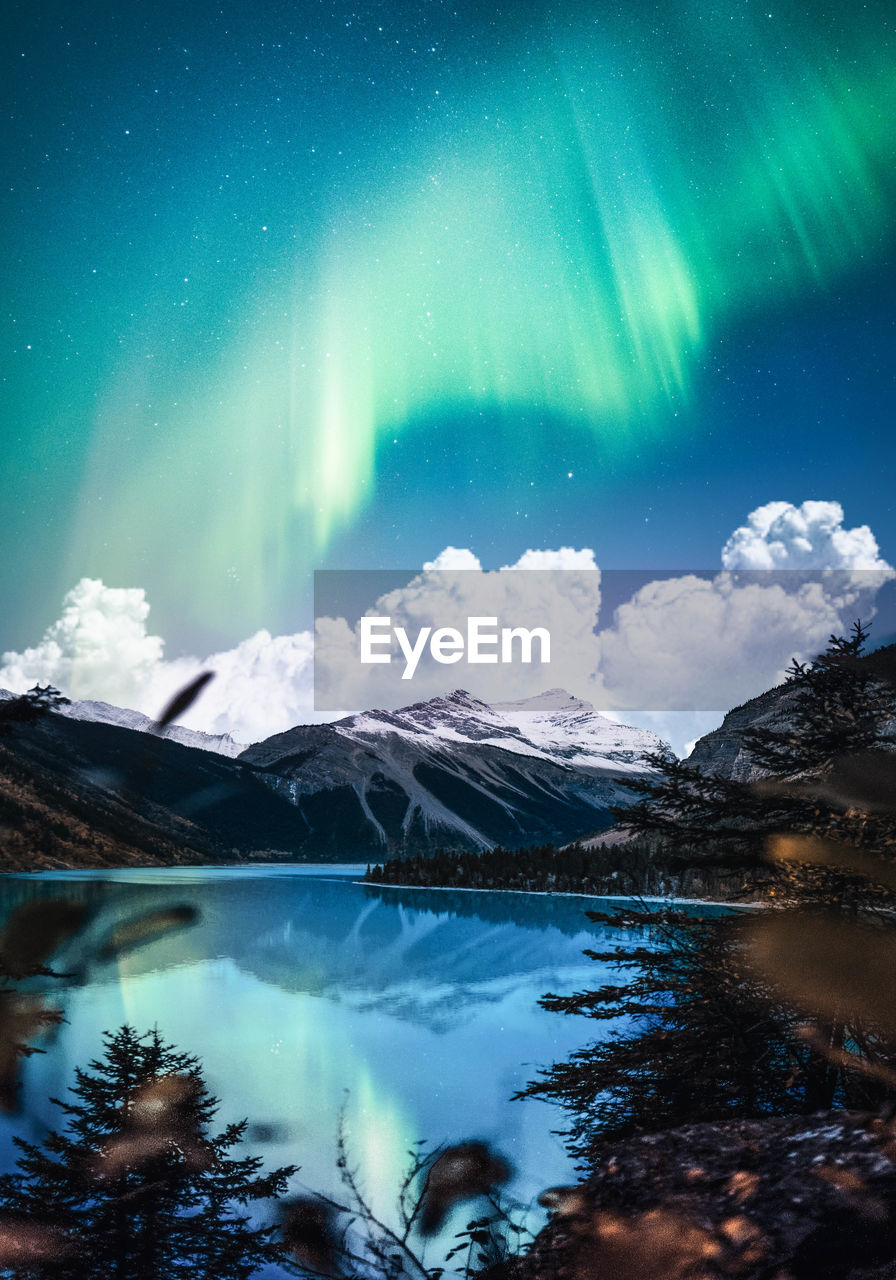 Scenic view of snowcapped mountains against sky at night