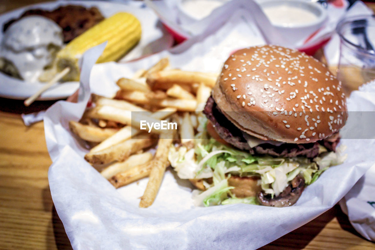 Close-up of burger and french fries on table