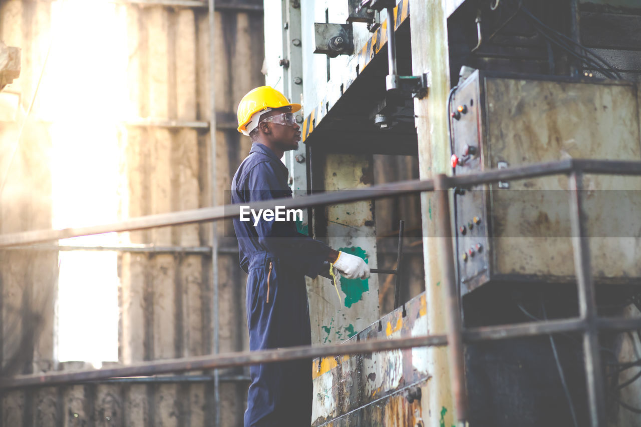 MAN WORKING AT CONSTRUCTION SITE IN OFFICE