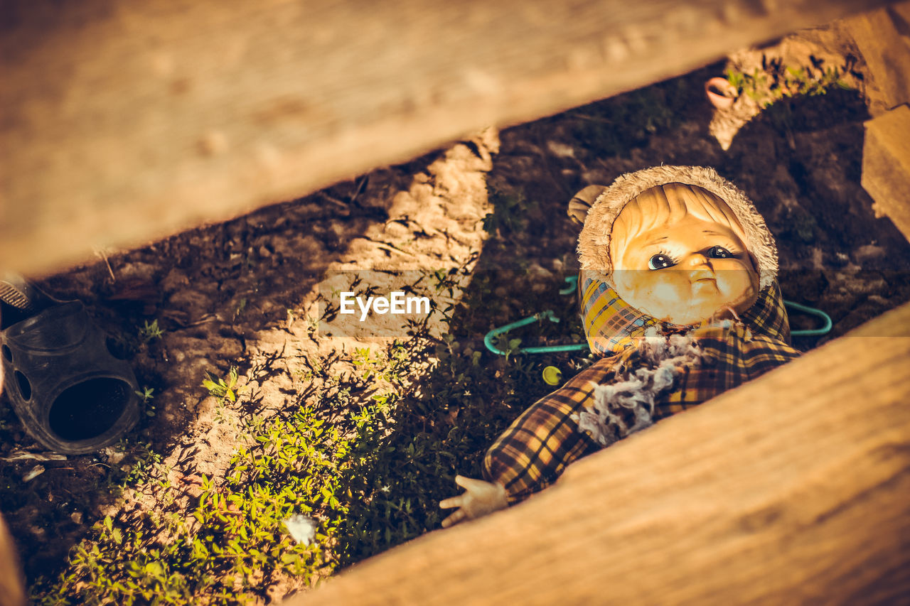 HIGH ANGLE VIEW PORTRAIT OF CHILD ON WOODEN FLOOR