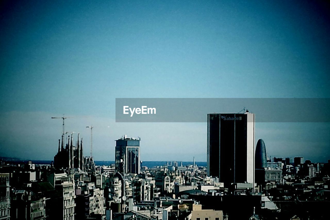 VIEW OF CITYSCAPE AGAINST BLUE SKY