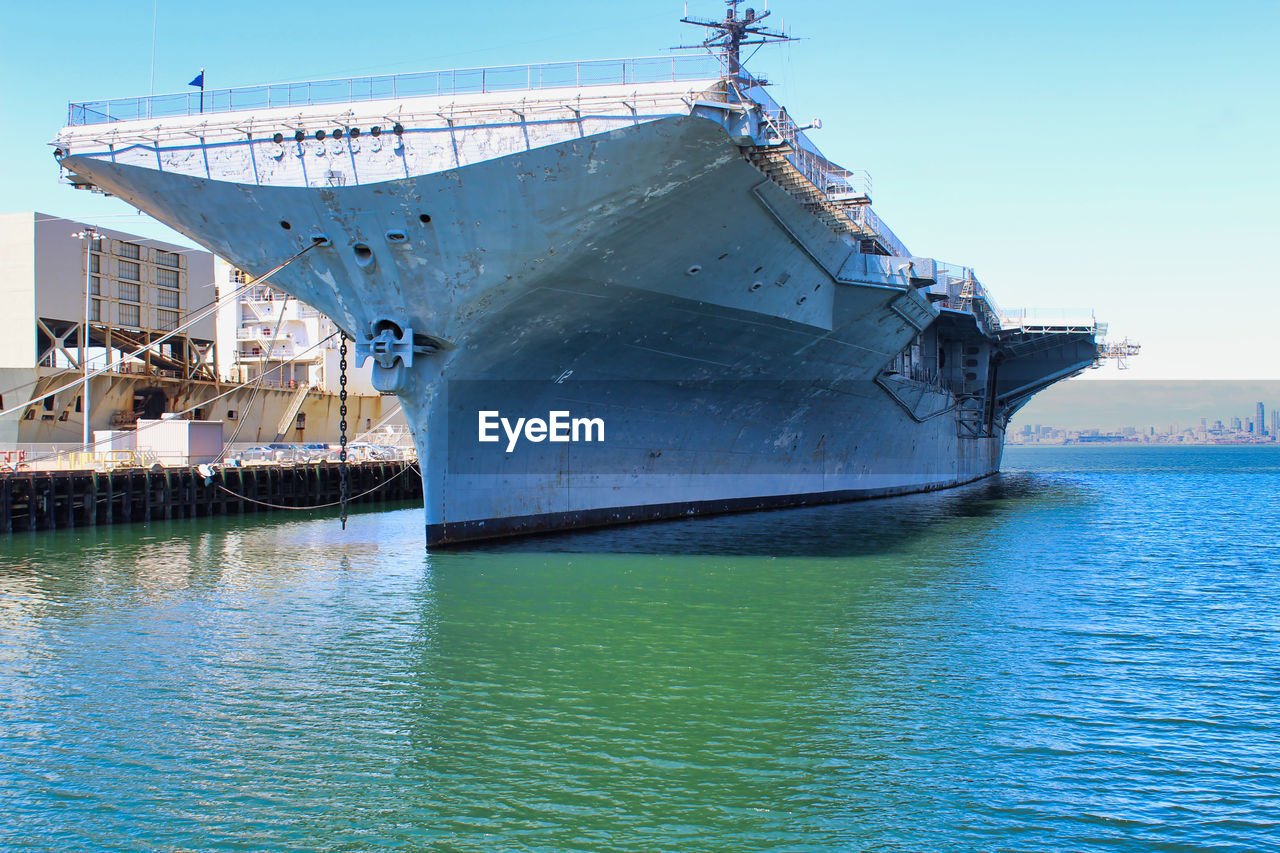 SHIP MOORED IN SEA AGAINST BLUE SKY