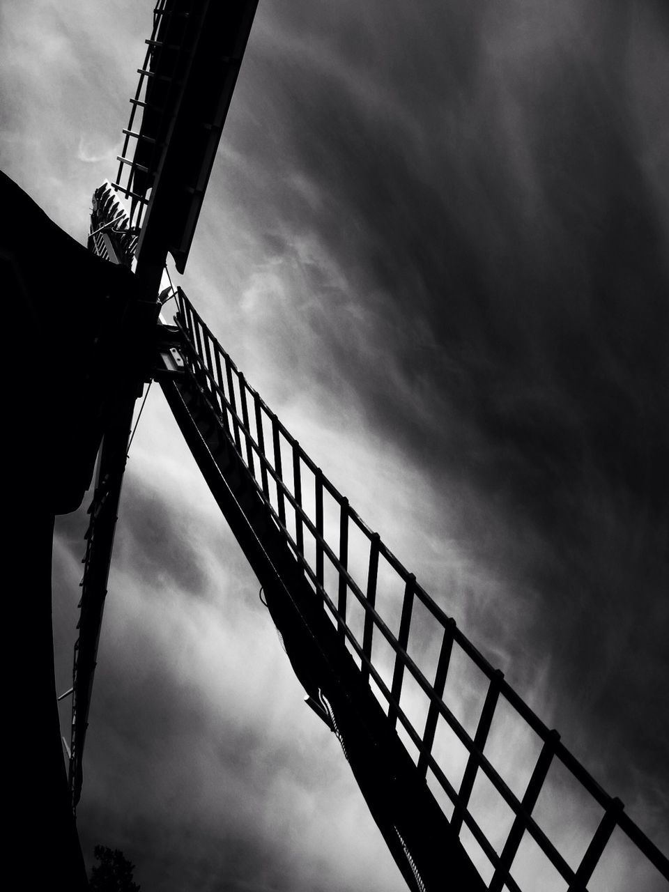 LOW ANGLE VIEW OF METAL STRUCTURE AGAINST CLOUDY SKY